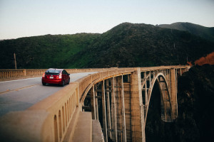 A car driving over a bridge.
