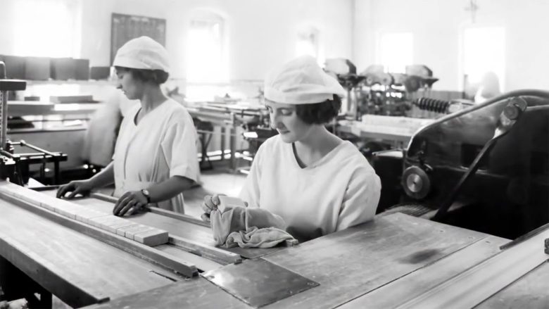 Two women work at a Proctor and Gamble factory